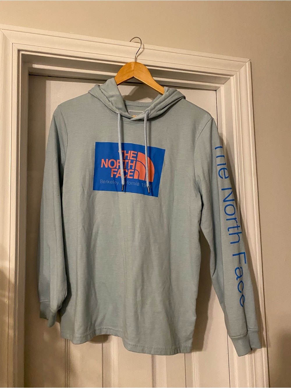 The North Face Light Blue Hoodie with Blue and Orange Logo